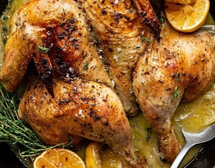 Skillet-Roasted Lemon Chicken garnished with fresh herbs, served hot in a skillet.