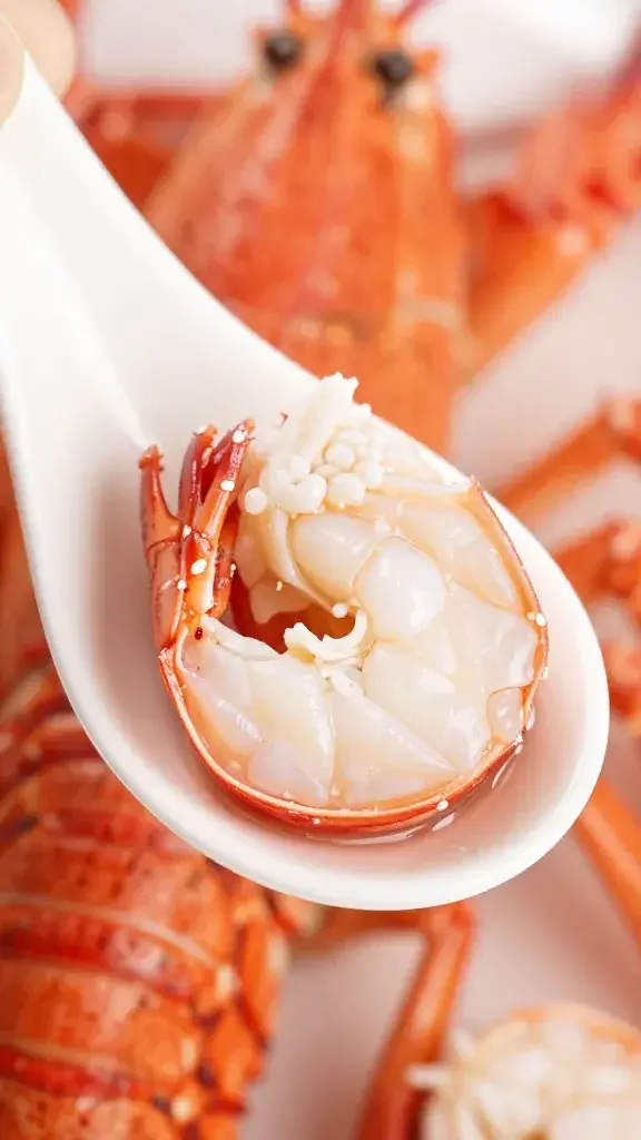 Closeup of lobster claw meat on a clean white spoon