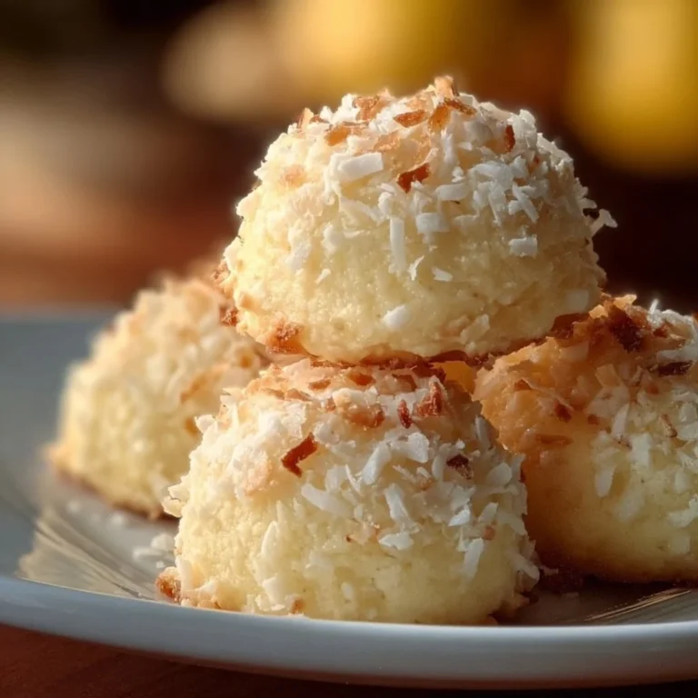 Lemon coconut cheesecake cookies on a plate, garnished with zest