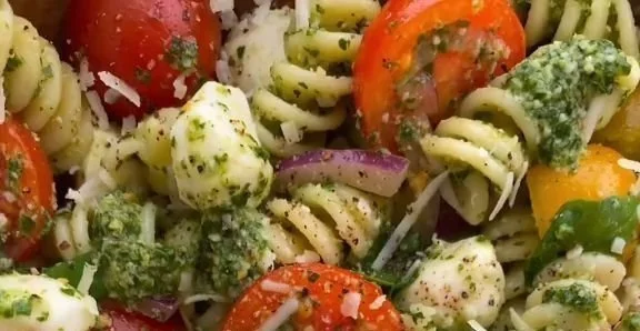 Delicious Pesto Pasta Salad with tomatoes and mozzarella cheese