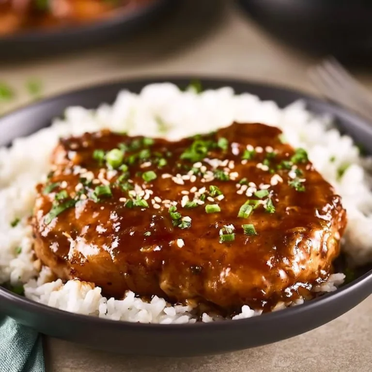 Delicious Crockpot Teriyaki Pork Chops served on a plate with rice and vegetables